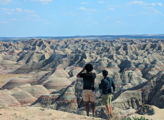 2 men looking out over Badlands National Park