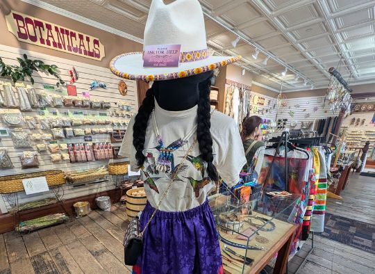 Botanical wall behind a mannequin in Prairie Edge Trading Co