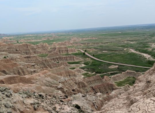 Looking down over a scenic drive road in Badlands National Park North Unit