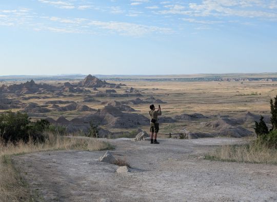 Men taking a photo from an overlook in Badlands National Park
