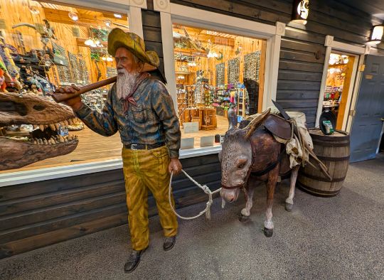 Statue of old man leading a donkey in Wall Drug