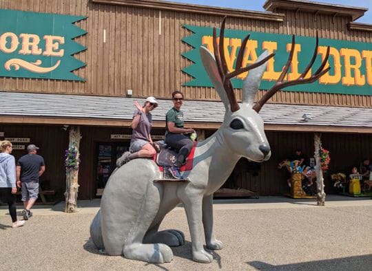 Two women on a giant jackelope at Wall Drug