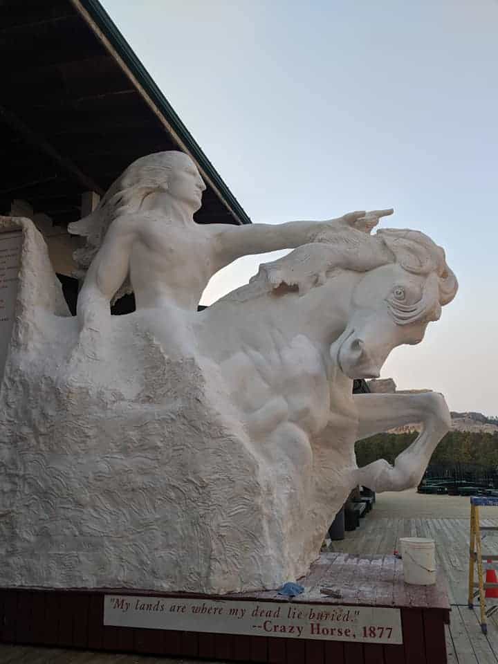 A smaller version of what the Crazy Horse Memorial will look like when its completed. It has  Crazy Horse riding a horse carved out of the rock. The top half of Crazy Horse and the front part of the horse is carved in detail.