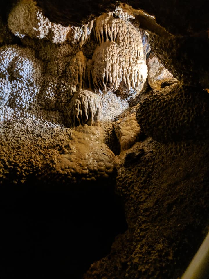 Cave formation inside Jewel Cave. It looks like frosting oozing down the sides of the cave.