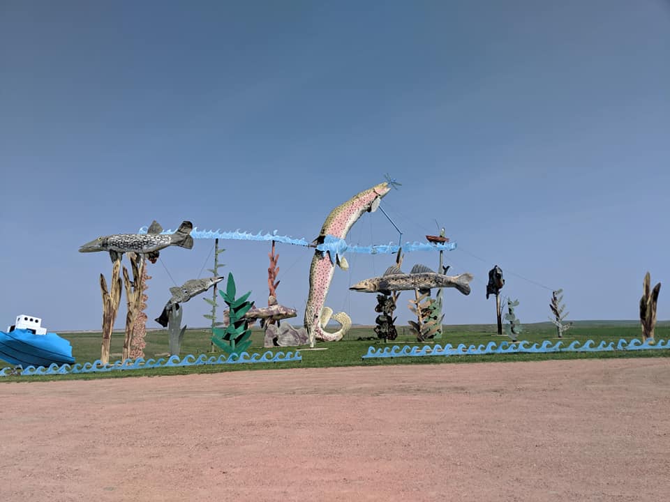 Gigantic sculpture on the side of Regent Enchanted Highway.  The Sculpture is a scene of multiple fish and coral.