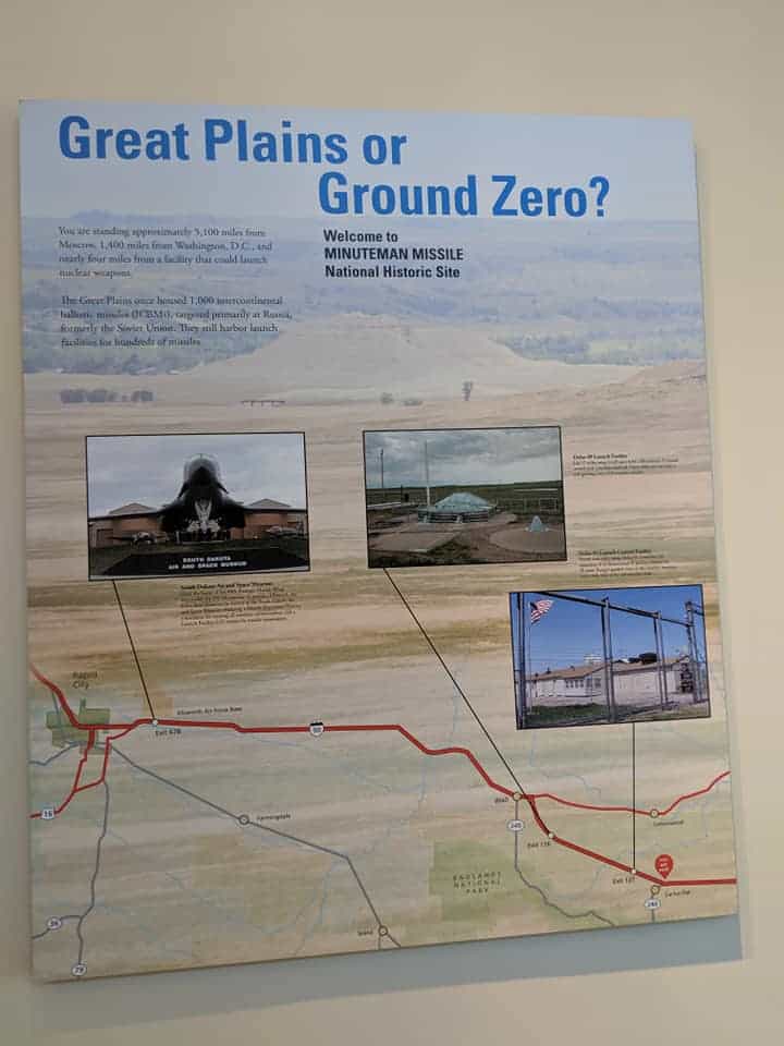 Informational sign inside the Minute Man Missile Silo NHS visitor center. Title of sign is "Great Plains or Ground Zero". Three pictures on the sign show the three different locations of this NHS. There are two paragraphs that discuss the site being in South Dakota.