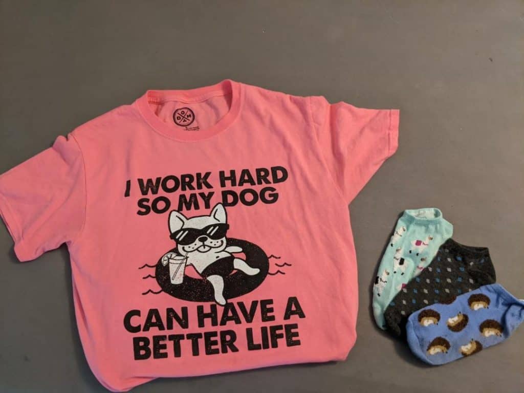 Pink shirt that says " I work hard so my dog can have a better life" and socks