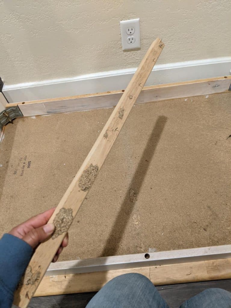 Dining room table is still upside down. This picture shows the removal of the crossbar that was under the top of the table which now makes the area flat.