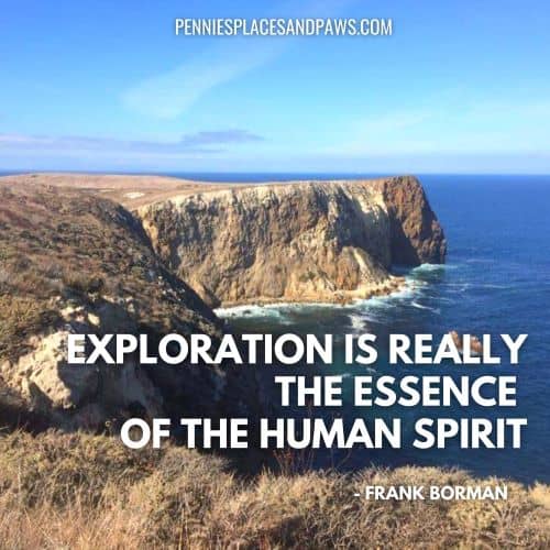 Quote: "Exploration is really the essence of the human spirit" Background is a mountain at the edge of a large body of water.