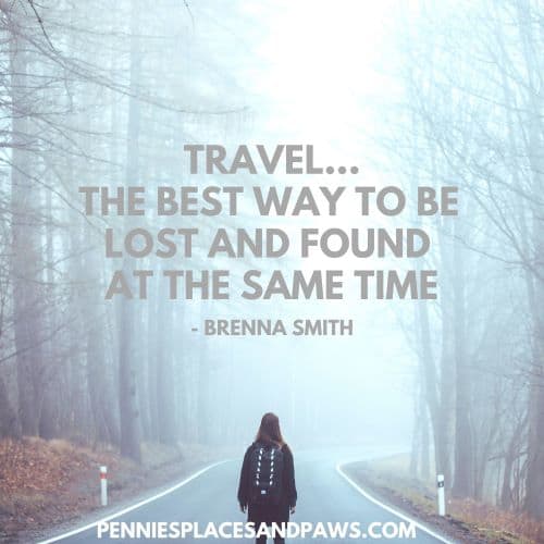 Quote: "Travel...The best way to be lost and found at the same time". Background is a woman walking down a street with trees on both sides, it is foggy.