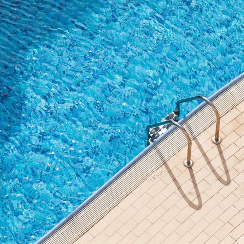 Clear and empty pool with a pool ladder