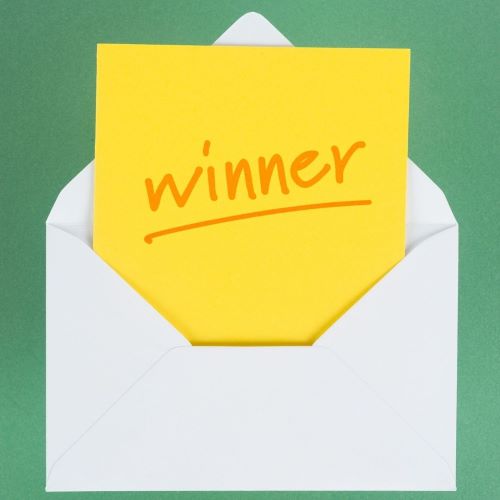 Envelope with a paper that says "Winner" coming out of it