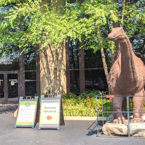 A dinosaur next to the entrance of the Creation Museum