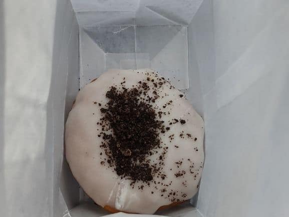 White frosted oreo donut with oreo crumbles on top