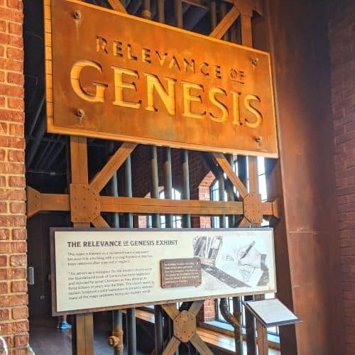 Large Gate with a sign that says "relevance of Genesis' on it at the start of the Genesis section of exhibits.