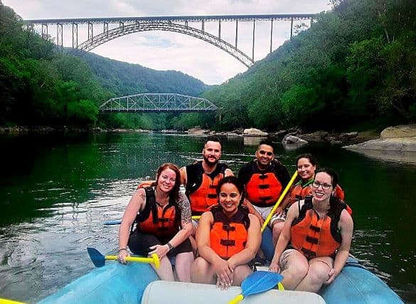 White-water-rafting-trip-with-friends-posed-under-New-River-Gorge