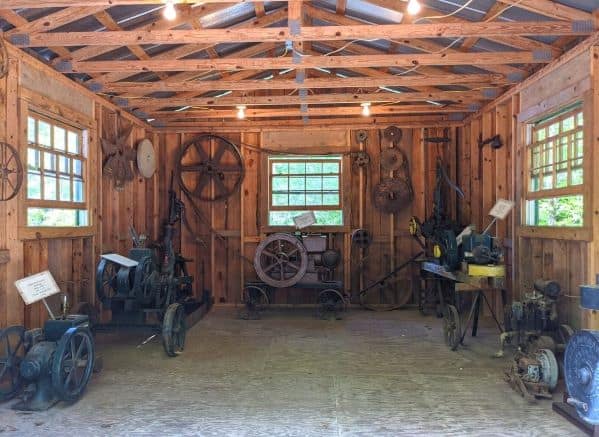 A wooden shed full of old mining equipment and tools