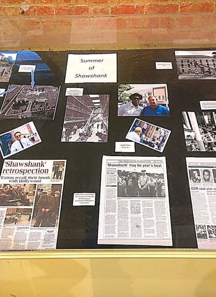 Photo of a collage board with pictures and news reports about the summer of Shawshank Redemption filming