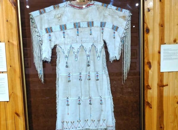 A Native American dress in a glass case