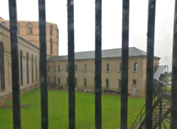 View of the courtyard and opposite side of building of the Ohio State Reformatory through a barred window