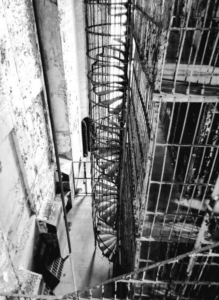 Black and white photo of a circular staircase in the prison