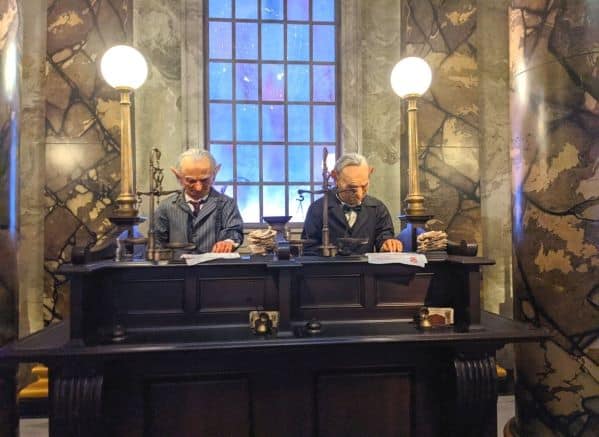 2 Goblins working next to each other behind a counter at Gringotts bank.