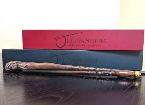 Ollivanders boxes and two wands displayed on a dark table