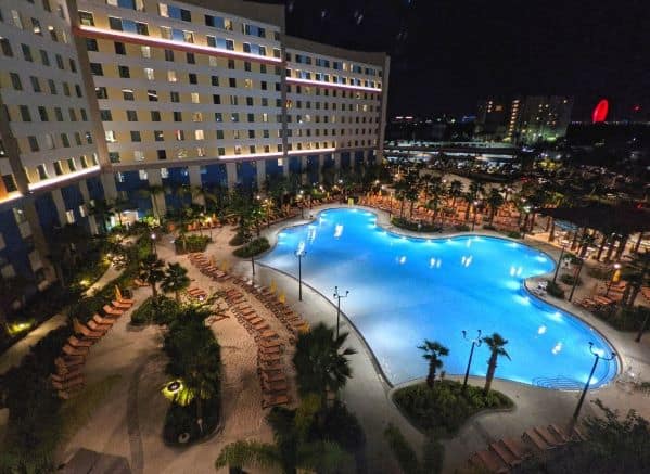 View of one of Dockside Inn's pools from an upper floor at night.