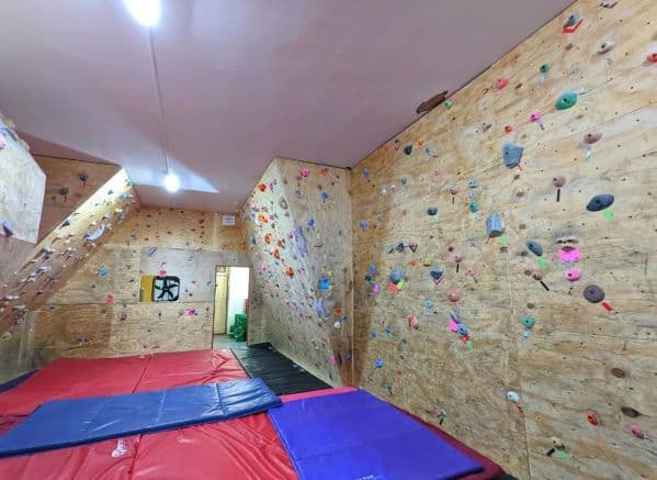 The climbing walls and crash pads inside of Climb Toledo