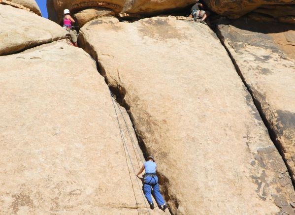 People lead climbing outdoors on a mountain