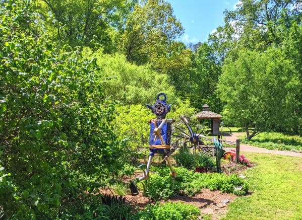 Metal robot sculpture in a garden