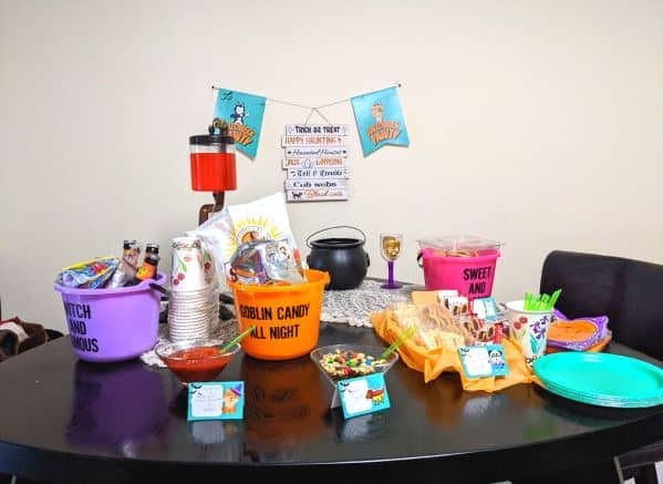 Halloween snack table with themed food tent labels and banners