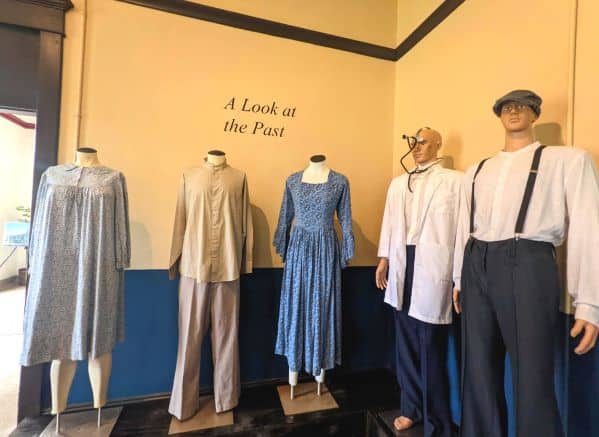 Row of manequins dressed in historical clothings in front of a sign that says A Look at the Past