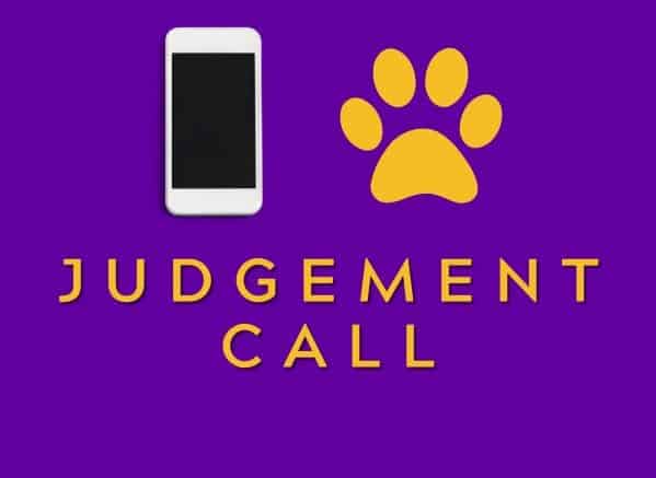 Judgement Call. Cell phone next to a paw print