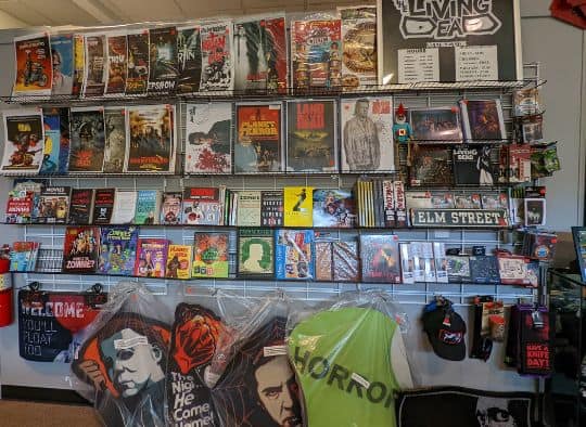 wall of zombie and horror movie merchandise in the Living Dead Museum Gift Shop