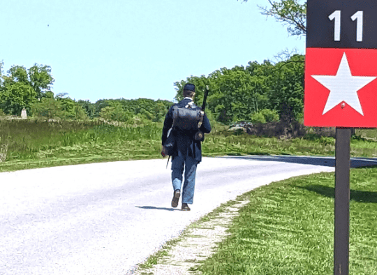 Union Soldier walking next to an Auto stop sign 