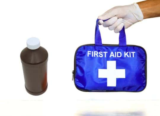 first aid kit next to a bottle of hydrogen peroxide