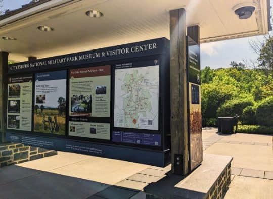 Large informational Outdoor sign with map and facts about Gettysburg National Park