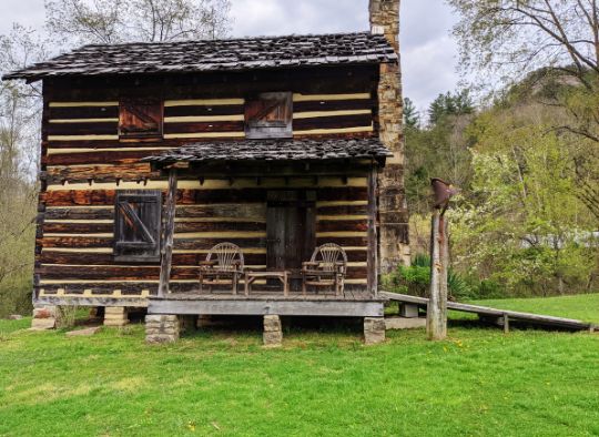 A two story historic wooden cabin near Gladie Visitor Center