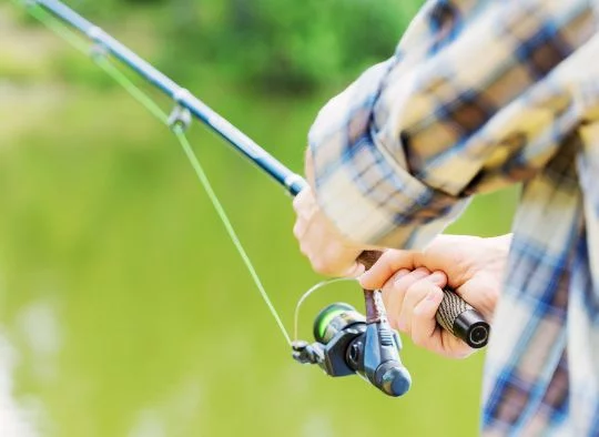 Close up of hands on a fishing pole