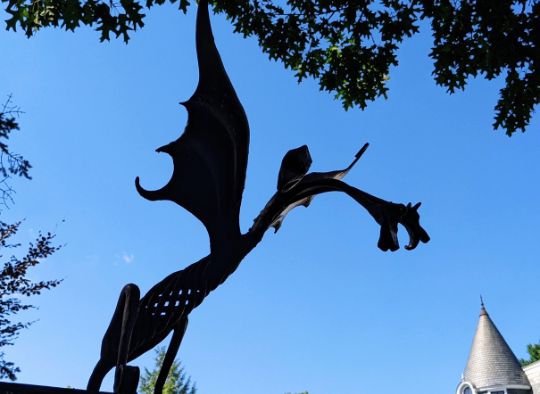 Dragon figurine on fence at Stephen King House