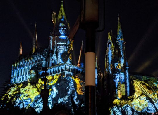 Universal's Halloween light show against Hogwarts castle
