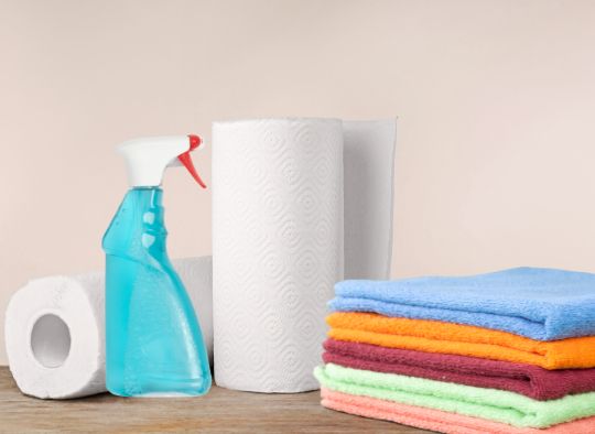 Paper towels, towels, and a cleaning spray bottle