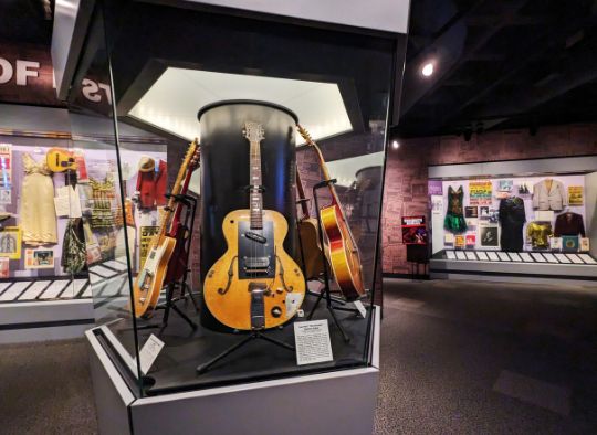 guitars and costumes on dipslay in Rock and Roll museum