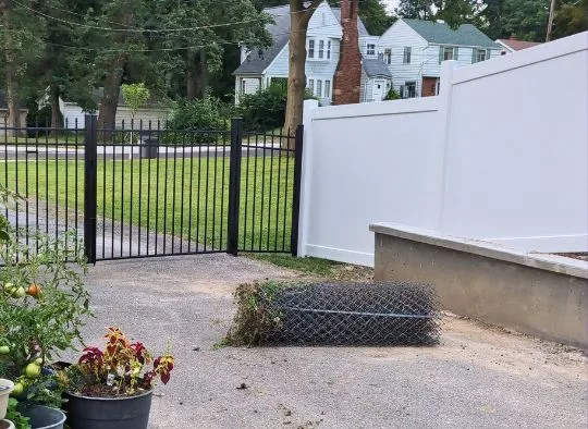 Rolled up chain link mesh after removing temporary fence