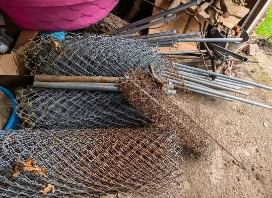 stack of used chain link pieces and parts stored in our garage