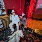 Man with two dogs next to Al Capone statue in Gangster Museum of America