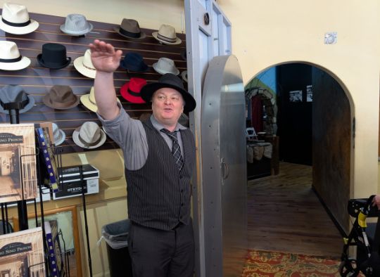 Tour guide opening door to the exhibit area of Gangster Museum of America