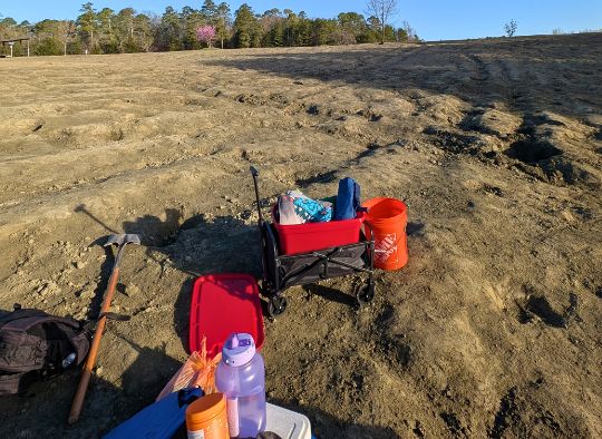 Equipment like wagon, bucket, and shovel in the diamond search area in crater of Diamonds