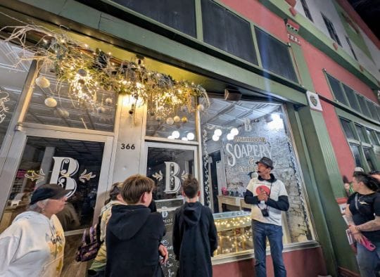 Guide talking in front of storefront on Hot Springs Haunted Tours